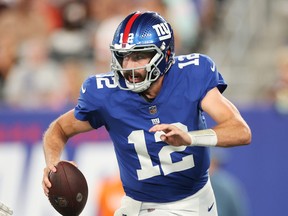 Davis Webb of the New York Giants looks to pass during the second half of a preseason game against the Cincinnati Bengals at MetLife Stadium on August 21, 2022 in East Rutherford, New Jersey. The Giants won 25-22.
