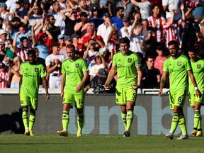 Manchester United's Harry Maguire looks dejected after Brentford's Ben Mee scores their third goal.