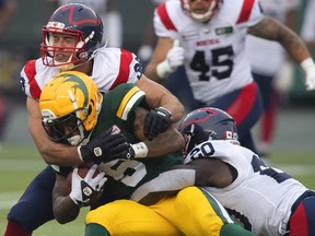 The Montreal Alouettes say player Christophe Normand has been suspended pending the outcome of a luring investigation. Normand (38) and Jeshrun Antwi (20) tackle Edmonton Elks' Terry Williams (5) during CFL action in Edmonton, Alta., on Saturday August 14, 2021.