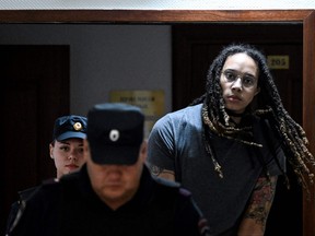 US Women National Basketball Association's (NBA) basketball player Brittney Griner, who was detained at Moscow's Sheremetyevo airport and later charged with illegal possession of cannabis, is escorted to the courtroom to hear the court's final decision in Khimki outside Moscow, on August 4, 2022.