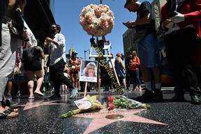 Flowers and photos are seen on the star of Australian singer and actress Olivia Newton-John on the Hollywood Walk of Fame in Hollywood, California, on Aug. 8, 2022.