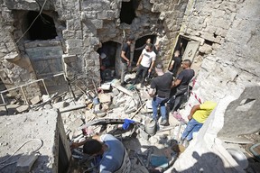 Palestinians search a house to evacuate the bodies of three Palestinians killed in an Israeli raid, in the West Bank city of Nablus on Aug. 9, 2022.