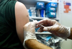 A pharmacist administers a dose of Imvanex, a vaccine to protect against Monkeypox virus, at a pharmacy in Lille, northern France, on Aug. 10, 2022.