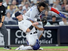 Blue Jays' Vladimir Guerrero Jr. slides safely into third on a single by Lourdes Gurriel Jr. (not pictured) ahead of the tag by Yankees' Josh Donaldson during the fifth inning at Yankee Stadium in New York on Thursday, Aug. 18, 2022.