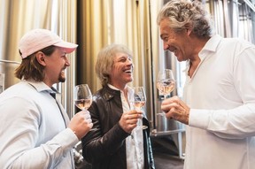 Jesse Bongiovi, left, dad Jon Bon Jovi, and French winemaker Gerard Bertrand, enjoying a glass of Hampton Water