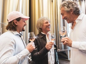 Jesse Bongiovi, left, dad Jon Bon Jovi, and French winemaker Gerard Bertrand, enjoying a glass of Hampton Water