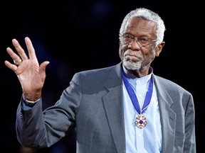 Celtics great Bill Russell stands with his Presidential Medal of Freedom during the NBA All-Star game in Los Angeles, Feb. 20, 2011.