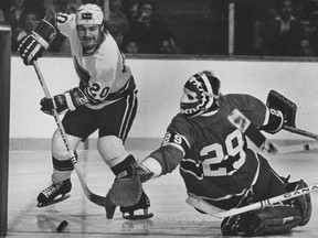 Bobby Lalonde of the Vancouver Canucks swoops in on Montreal Canadiens goalie Ken Dryden in National Hockey League playoff action on April 19, 1975. The puck went wide and the Canucks lost the game 4-0.