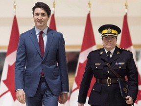 Brenda Lucki, center, Prime Minister Justin Trudeau, left, and Ralph Goodale, minister of public safety and emergency preparedness enter a press event at RCMP "Depot" Division in Regina, Saskatchewan on Friday March 9, 2018. Lucki, who was Depot's commanding officer, was appointed Canada's first permanent female RCMP commissioner. THE CANADIAN PRESS/Michael Bell