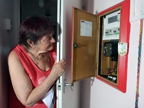 Pensioner Diane Skidmore examines her smart meter in London, England, Thursday, Aug. 25, 2022.