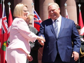Sylvia Jones, Deputy Premier and Minister of Health, shakes hands with Premier Doug Ford as she takes her oath at the swearing-in ceremony at Queen’s Park in Toronto on June 24, 2022.