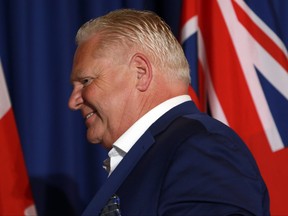 Ontario Premier Doug Ford leaves the stage on the final day of the summer meeting of Canada's premiers at the Fairmont Empress in Victoria, B.C., on Tuesday, July 12, 2022.