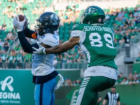 Toronto Argonauts defensive back DaShaun Amos intercepts an intended pass to Saskatchewan Roughriders receiver Kian Schaffer-Baker during second quarter of CFL football action against Toronto Argonauts in Regina, on Sunday, July 24, 2022.