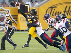 Hamilton Tiger Cats quarterback Matthew Shiltz (18) tries to throw to prevent the sack by Montreal Alouettes defensive back Adarius Pickett (6) during first half CFL football game action in Hamilton, Ont. on Thursday, July 28, 2022.
