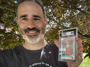 This photo provided on Wednesday, Aug. 3, 2022, shows Allie Tarantino holding a baseball card featuring a very young Mark Zuckerberg grinning in a red jersey and gripping a bat.