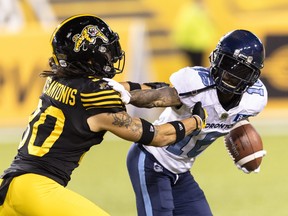 Toronto Argonauts wide receiver Brandon Banks (16) straight-arms  Hamilton Tiger-Cats defensive back Stavros Katsantonis (30) during second half CFL football game action in Hamilton, Ont. on Friday, August 12, 2022.