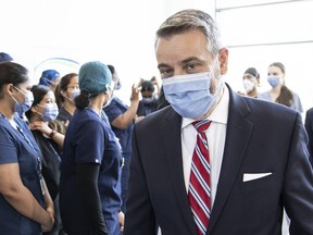 Ontario Minister for Long Term Care Paul Calandra, walks past health-care workers after an announcement at Toronto’s Sunnybrook Hospital, Thursday,  August 18, 2022.