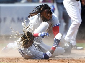 Blue Jays Vladimir Guerrero Jr., top, collides with teammate Raimel Tapia after trying to score simultaneously on an Alejandro Kirk double in the fifth inning yesterday against the New York Yankees. Tapia was safe on the play, but Guerrero was tagged out.