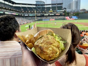 Take in an Orioles ball game while eating a crab cake sandwich from Jimmy’s Famous Seafood at Oriole Park at Camden Yards. EDDIE CHAU/TORONTO SUN