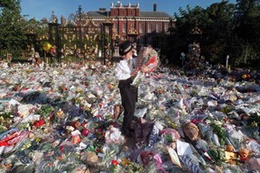 BLIZZARD: The iconic Princess Diana died far too young 25 years ago 5 A British policewoman picks up some of the bouquets of flowers left outside Kensington Palace in London, the former residence of the Princess of Wales - DIANA, September 02.