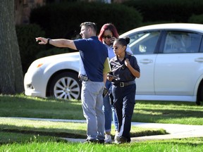 Detroit Police and investigators look over a shooting scene on Pennington Drive, north of Seven Mile Road, Sunday, Aug. 28, 2022, in Detroit.