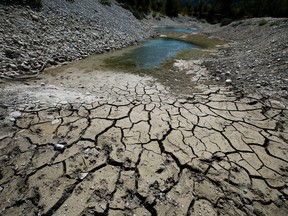 Cracked and dry earth is seen on the banks of Le Broc lake, as a historical drought hits France, August 5, 2022.