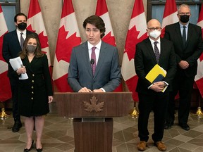 Public Safety Minister Marco Mendicino, Deputy Prime Minister Chrystia Freeland, Justice Minister David Lametti and Emergency Preparedness Minister Bill Blair stand behind Prime Minister Justin Trudeau as he announces the Emergencies Act will be invoked to deal with protests in Ottawa, February 14, 2022.