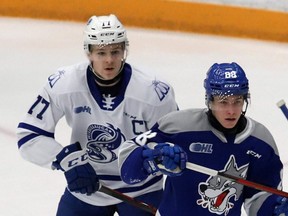 Ethan Del Mastro, left, of the Mississauga Steelheads, battles for position with David Goyette of the Sudbury Wolves during OHL action at the Sudbury Community Arena in Sudbury, Ont., Jan. 7, 2022.