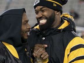 Brandon Banks, left, jokes with then Ticats teammate Simoni Lawrence during warmup before a game against the Toronto Argonauts, in Hamilton, Ont., Saturday, Nov. 2, 2019.