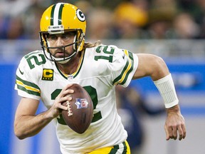 Green Bay Packers quarterback Aaron Rodgers runs the ball during the first quarter against the Detroit Lions at Ford Field.