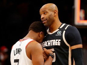 Vince Carter #15 of the Atlanta Hawks and Kyle Lowry #7 of the Toronto Raptors hug after the Raptors 122-117 win at State Farm Arena on January 20, 2020 in Atlanta, Georgia.