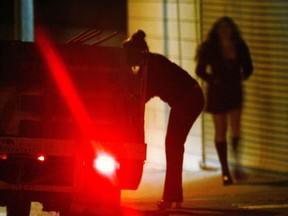 A car slows down for two female police officers posing as prostitutes during a major prostitution sting operation. (Photo by David McNew/Getty Images)