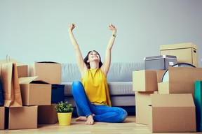 Happy young woman moving into new home. GETTY IMAGES