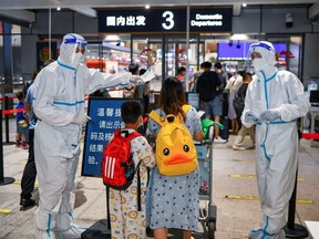 Tourists who were stranded amid the new outbreak of COVID-19 arrive at the departure hall of Haikou Meilan International Airport in Haikou, Hainan, China, Thursday, Aug. 11, 2022.
