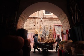 A man pulls a wagon through the narrow streets of the medina in Marrakech. Photo by Pamela Roth.