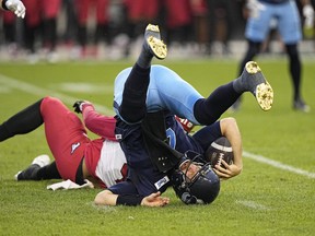 Toronto Argonauts quarterback McLeod Bethel-Thompson (4) gets sacked by Calgary Stampeders defensive lineman Mike Rose (41) during the first half at BMO Field.