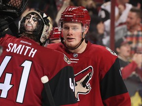 Lawson Crouse, right, of the Arizona Coyotes celebrates with goaltender Mike Smith after defeating the Nashville Predators in the NHL game at Gila River Arena on Dec. 10, 2016 in Glendale, Ariz.