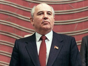 In this file photo taken March 15, 1990, Soviet President Mikhail Gorbachev poses solemnly as he takes the oath at the Congress of Deputies, in Moscow.