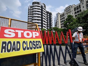Police barricades cordon off a road near the residential twin tower which is slated for demolition by controlled implosion on August 28, in Noida on the outskirts of New Delhi on August 26, 2022.