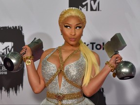 Trinidadian-U.S. rapper Nicki Minaj poses backstage with her awards during the MTV Europe Music Awards at the Bizkaia Arena in the northern Spanish city of Bilbao on Nov. 4, 2018.