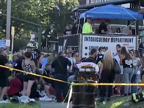 Emergency personnel attend the scene where a car was driven into a crowd during a benefit for families of the Nescopeck fire victims at the Intoxicology Department bar in Berwick, Pa, Aug. 13, 2022 in a still image from video.