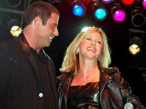 Actor John Travolta and Australian singer Olivia Newton-John perform a song from their musical film "Grease" during a party at Paramount studios Sept. 24, 2002 in Hollywood celebrating the DVD release of six classic musical films including "Grease," "Saturday Night Fever," "Flashdance," and "Footloose."