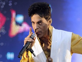 This June 30, 2011 file photo shows singer and musician Prince performing on stage at the Stade de France in Saint-Denis, outside Paris.