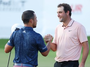 Xander Schauffele of the United States and Scottie Scheffler of the United States shake hands after finishing 18 during the second round of the TOUR Championship at East Lake Golf Club on Aug. 26, 2022 in Atlanta, Ga.