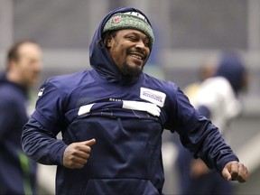 Then Seattle Seahawks running back Marshawn Lynch stretches during warmups at the NFL football team's practice facility Tuesday, Dec. 24, 2019, in Renton, Wash.