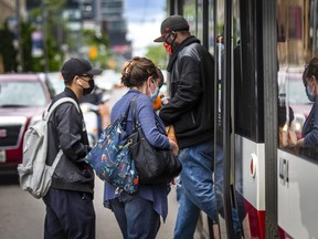 TTC passengers board a TTC streetcar at College St. and University Ave., in Toronto, Ont. on Thursday, June 9, 2022.