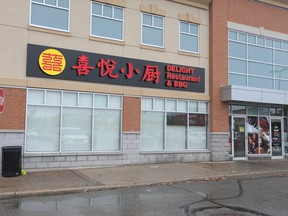 Patrons arrive on Tuesday, Aug. 30, 2022, to find the doors of Delight Restaurant and BBQ at Markham Rd. and Castlemore Ave. were shut closed. A sign posted by the York Region Public Health cited it was closed after close to a dozen people became seriously ill after allegedly eating there over the weekend.
