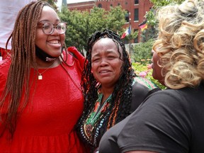 Tamika Palmer (centre), Breonna Taylor's mother, celebrates with community members after the announcement that the FBI arrested and brought civil rights charges against four current and former Louisville police officers for their roles in the 2020 fatal shooting of Breonna Taylor, in Louisville, Ky., Aug. 4, 2022.