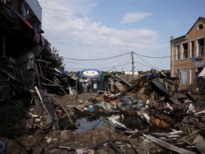 Sergey Vlasov walks on a destroyed street market in Bakhmut after a military strike, as Russia's invasion of Ukraine continues, in Donetsk region Ukraine on Sunday, Aug. 14, 2022.