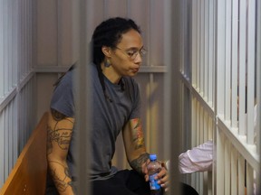 U.S. basketball player Brittney Griner, who was detained at Moscow's Sheremetyevo airport and later charged with illegal possession of cannabis, sits inside a defendants' cage after the court's verdict in Khimki outside Moscow, Russia August 4, 2022.